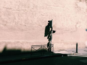 Full length of woman standing on wall