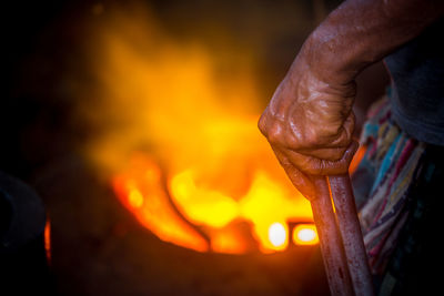 Close-up of hand holding bonfire