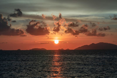 Scenic view of sea against romantic sky at sunset