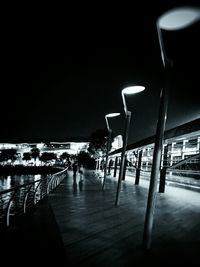 View of illuminated pier at night