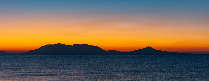 Sunrise at 6 o'clock in the morning from the beach on the mediterranean in front of kos greece