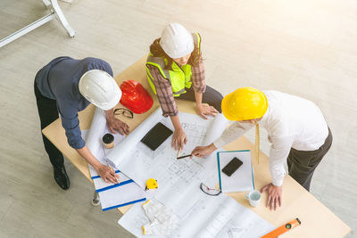 High angle view of people working on table