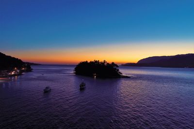 Scenic view of sea against sky at dusk