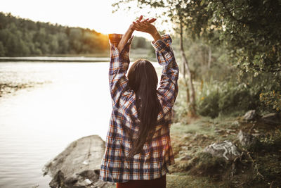 Rear view of woman standing in water