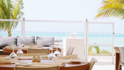 Empty chairs and tables at seaside