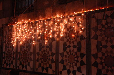 Low angle view of illuminated lights at night