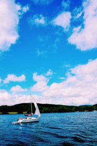 Boat sailing in sea against sky