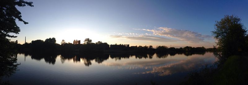 Scenic view of calm lake at sunset