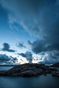 Scenic view of lake against cloudy sky