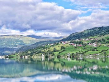 Scenic view of lake and mountains against sky