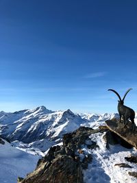 Scenic view of snowcapped mountains against clear sky