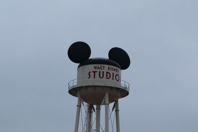 Low angle view of sign against clear sky