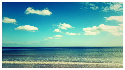 Scenic view of sea against cloudy sky