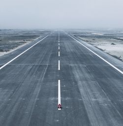Airplane on road against sky