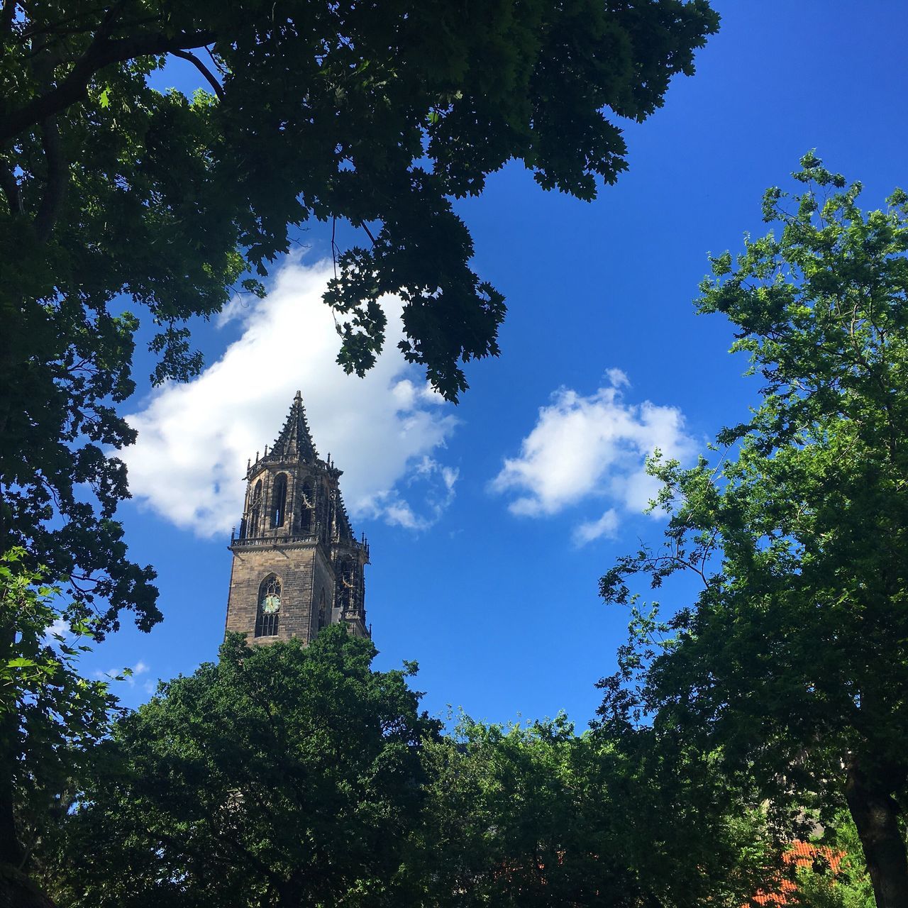 LOW ANGLE VIEW OF BELL TOWER AGAINST BLUE SKY