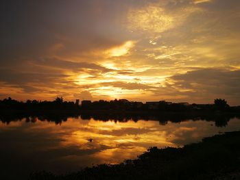 Scenic view of lake against sky during sunset