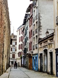 Man walking by residential buildings