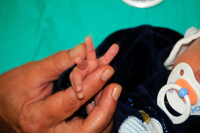 Close-up of mother and baby hands