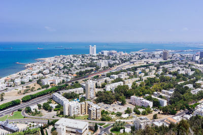 High angle view of cityscape by sea against sky