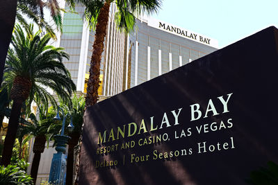 Low angle view of information sign by building