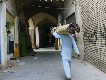 Full length of man walking in alley