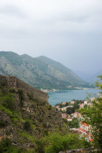 High angle view of townscape by sea against sky