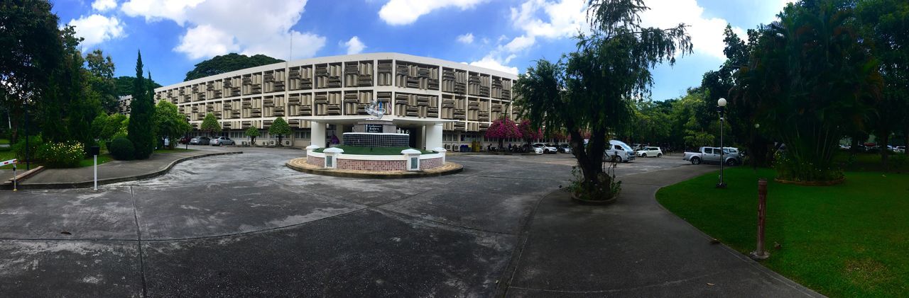 built structure, architecture, tree, building exterior, city, sky, plant, cloud - sky, day, street, nature, transportation, incidental people, road, outdoors, panoramic, building, city street, sign, mode of transportation