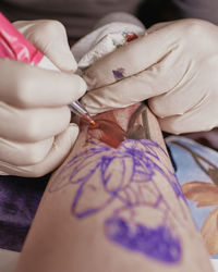 Close-up of hand tattooing