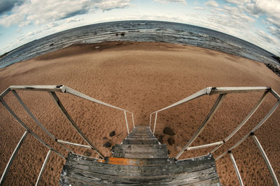 High angle view of land and sea against sky