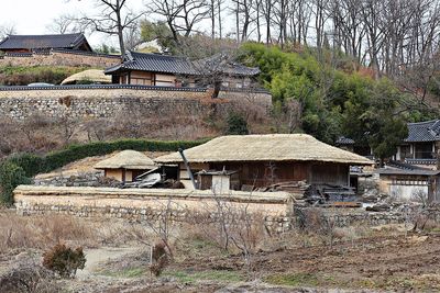 Old house on field by building