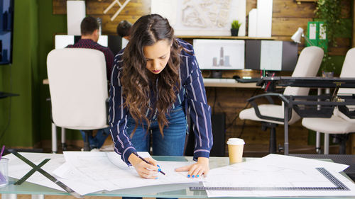Young businesswoman working at desk in office
