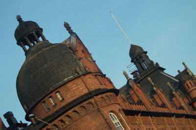 Low angle view of old building against clear blue sky