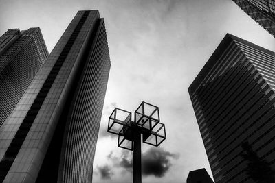 Low angle view of modern building against cloudy sky