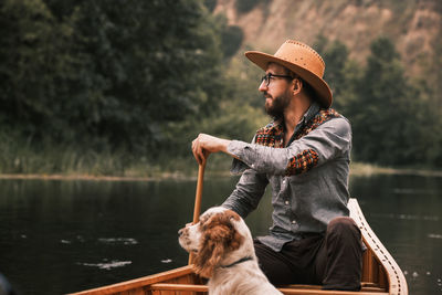 Man and dog in canoe on the river