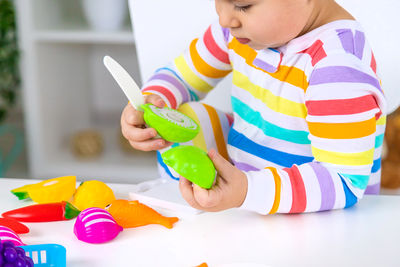 Close-up of boy playing with toys