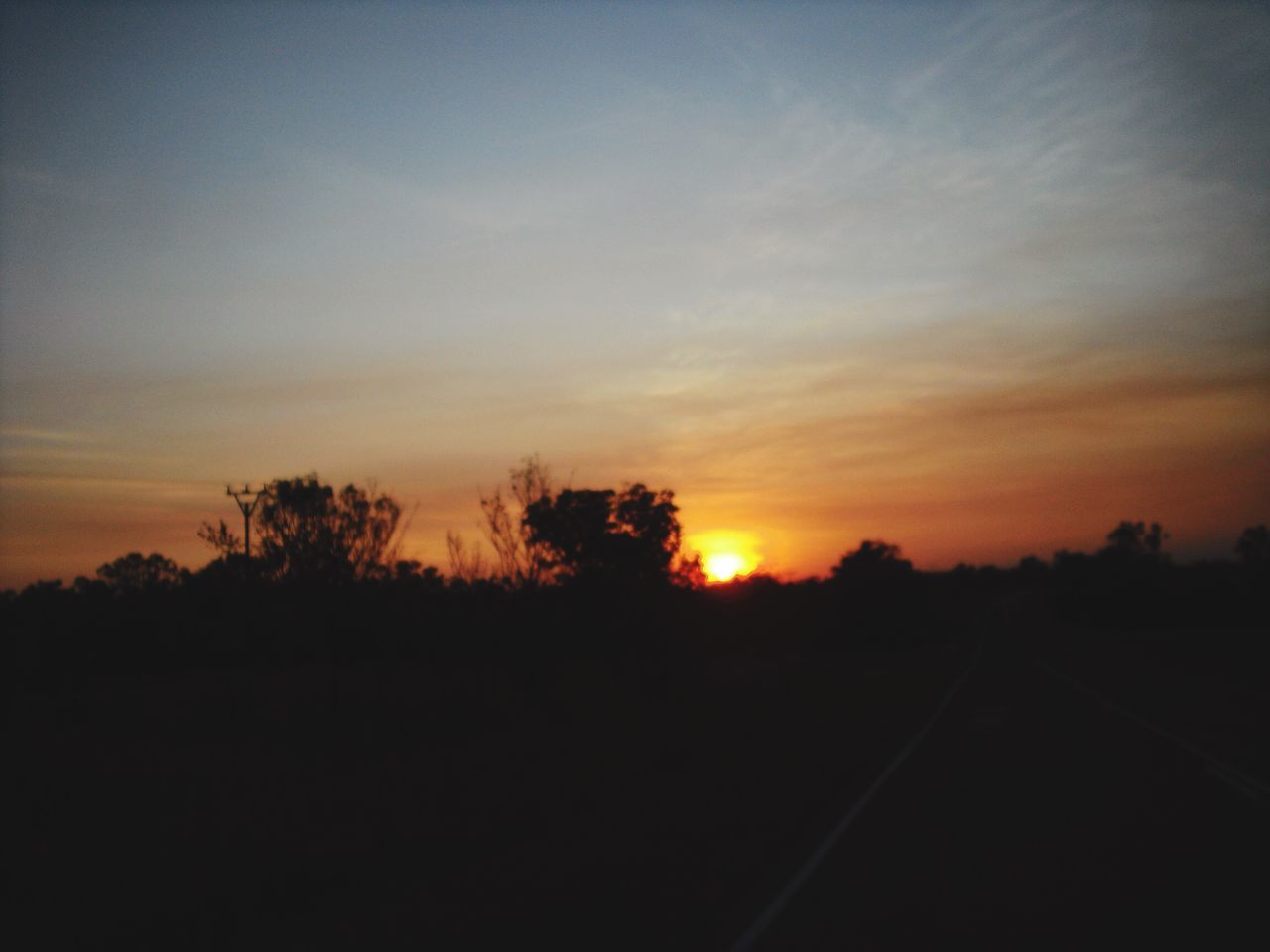 sunset, silhouette, orange color, tranquility, sky, scenics, tranquil scene, beauty in nature, tree, nature, landscape, idyllic, cloud - sky, outdoors, no people, dark, sun, copy space, field, non-urban scene