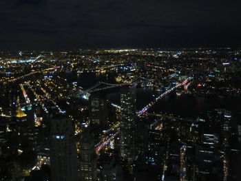 Aerial view of city lit up at night