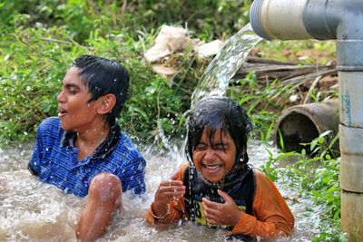 Portrait of smiling children in water