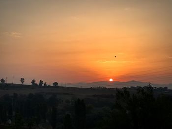 Scenic view of silhouette landscape against sky during sunset