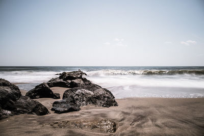 Scenic view of beach against clear sky