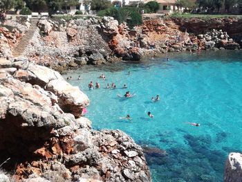 High angle view of people swimming in sea