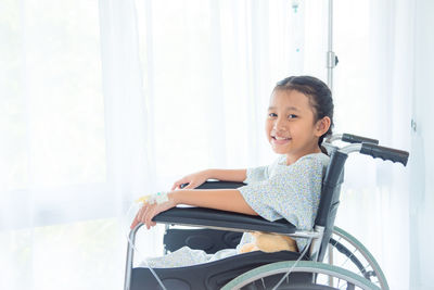 Portrait of smiling girl sitting at home