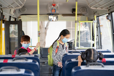 Rear view of people sitting in bus