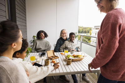 Family sitting at table on balcony