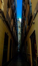 Narrow alley amidst buildings in city