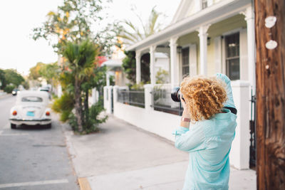 Rear view of woman standing on street