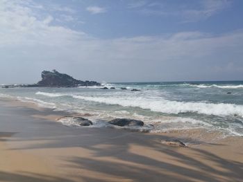 Scenic view of beach against sky