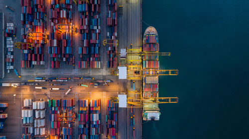 Illuminated commercial dock against sky at night