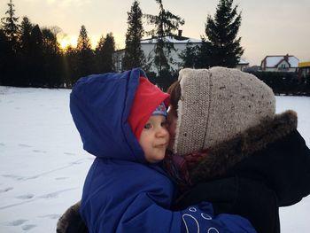 Close-up portrait of smiling boy in snow