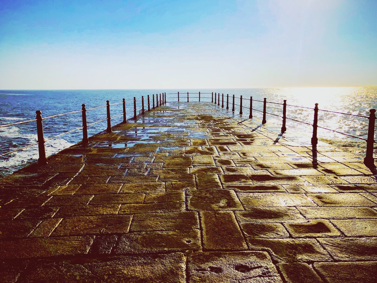 WOODEN PIER ON SEA AGAINST SKY